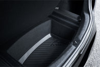 A close-up view of the JOWUA Model 3 All Weather Trunk Combo for the reengineered Model 3 Highland (2024+) displays a sleek, textured surface. Made from waterproof TPE material, this trunk features a dark-toned, logo-embedded design with a visible edge at the top.
