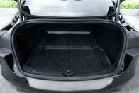 The open trunk of a black Tesla Model 3 features the Model 3 All Weather Trunk Combo by JOWUA, showcasing a clean, empty interior lined with a black textured rubber mat made from waterproof TPE material. With its grooves and the "Tesla" embossment near the back, the well-lit space underscores its spacious cargo area.