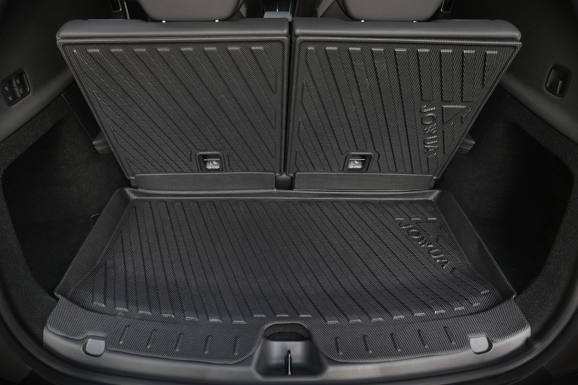Close-up of a Model Y L (2026+) trunk with upright back seats, showcasing the black JOWUA waterproof trunk liner and rear seat back cover bundle, featuring textured diagonal ridges for precision-fit protection and enhanced grip.
