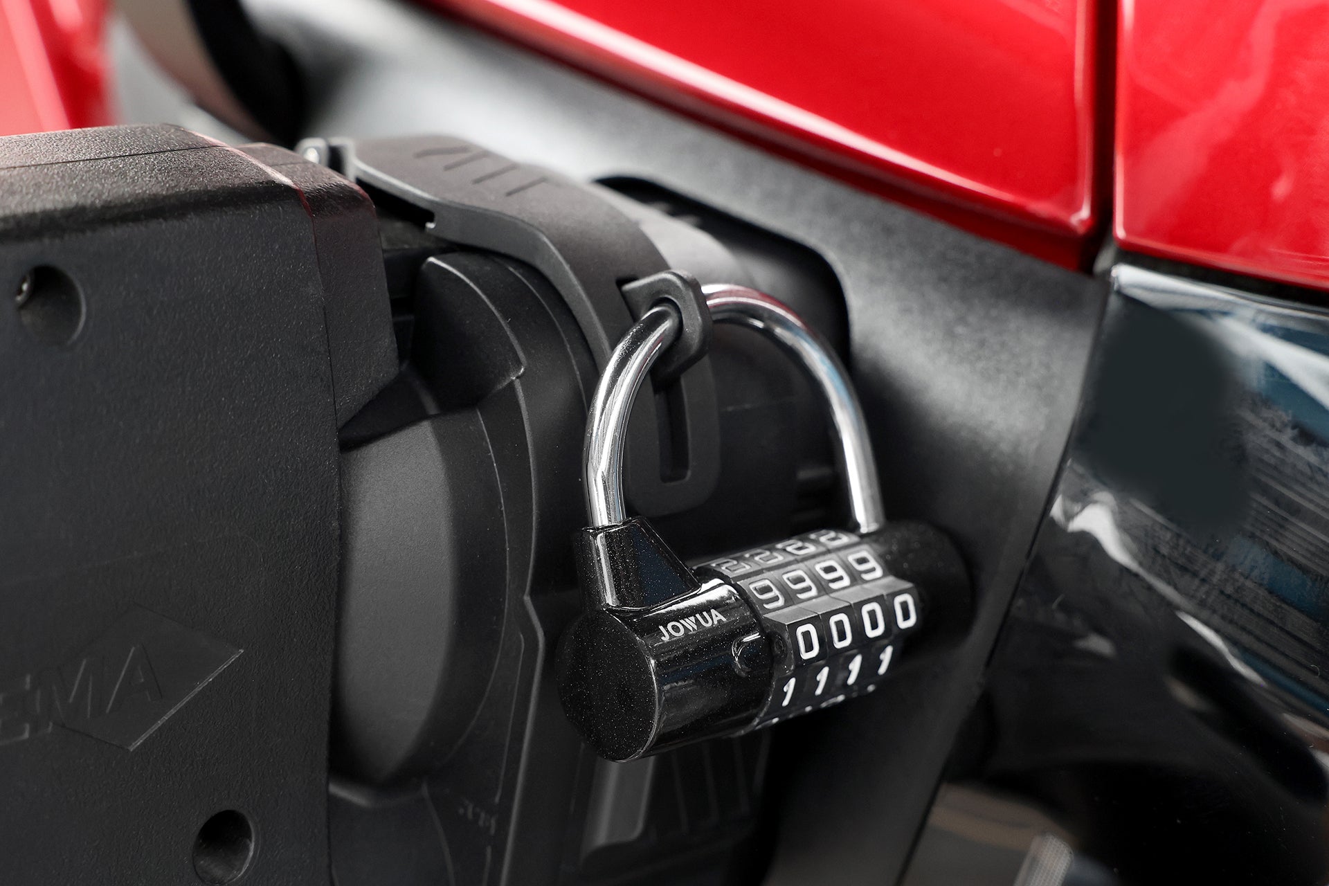 A close-up of the JOWUA CCS1 to CCS2 DC & AC Combined Adapter showcases secure EV charging compatibility, set against a striking red and black background.