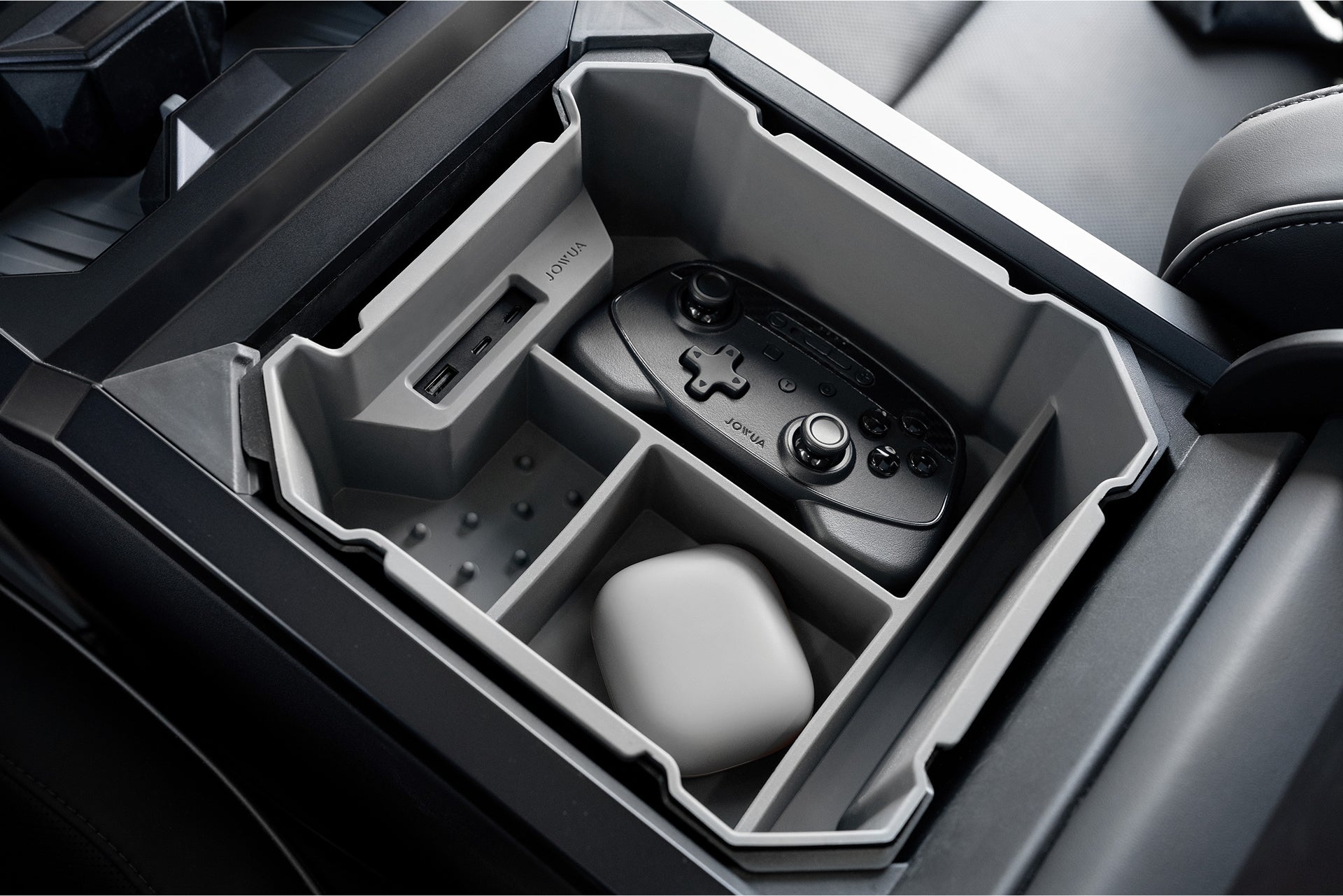 The JOWUA Center Console Set for Tesla Cybertruck organizes a Nintendo Switch Joy-Con controller, small white case, SD card, and silicone cup coasters in separate sections for neat storage.