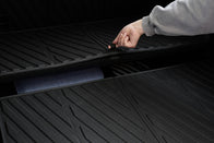 A hand lifts the textured black JOWUA Model Y EasyShield Waterproof Trunk Liner + Rear Seats Back Cover Bundle (Juniper 2025+/2018-2024), revealing extra storage space beneath.