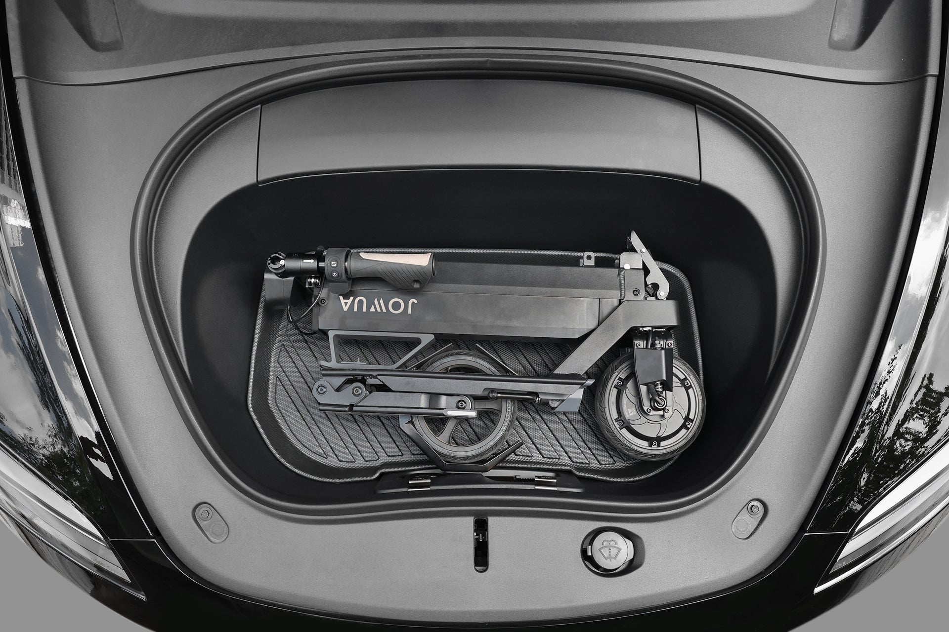 The JOWUA Folding Electric Scooter｜Performance fits compactly in a car’s frunk, showcasing its space-saving design, long-range battery, and impressive portability.