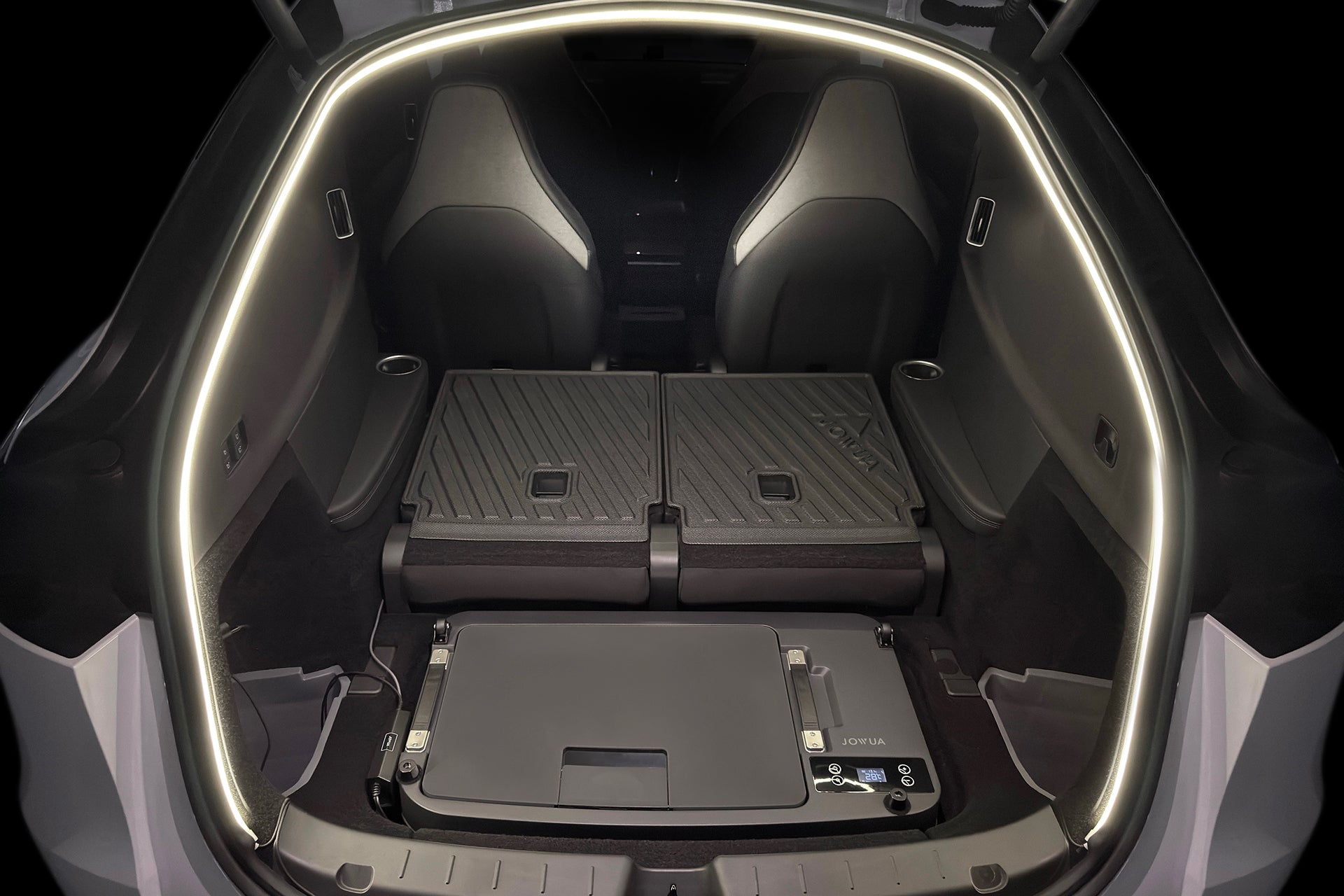 A JOWUA Car Refrigerator for Tesla Model Y L (2026+) with intelligent dual-mode cooling installed in the trunk of an electric SUV, positioned behind the folded rear seats.