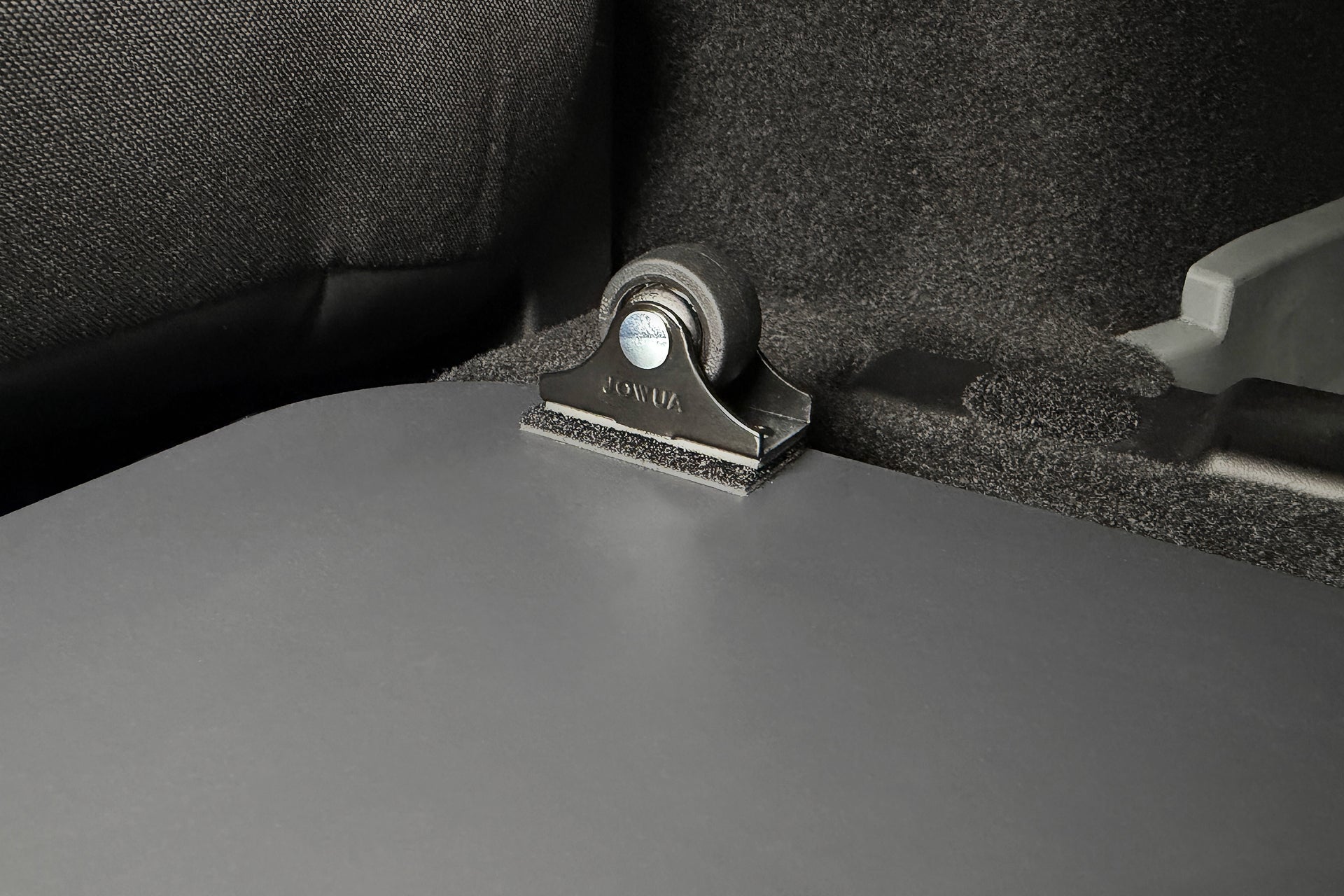 A small black wheel mounted on a bracket inside a Car Refrigerator for Tesla Model Y L (2026+) cargo area, part of the dual-track power supply system.
