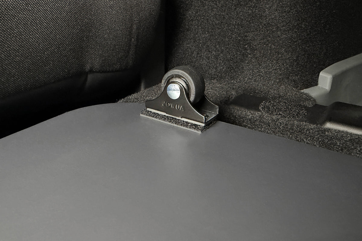 A small black wheel mounted on a bracket inside a Car Refrigerator for Tesla Model Y L (2026+) cargo area, part of the dual-track power supply system.