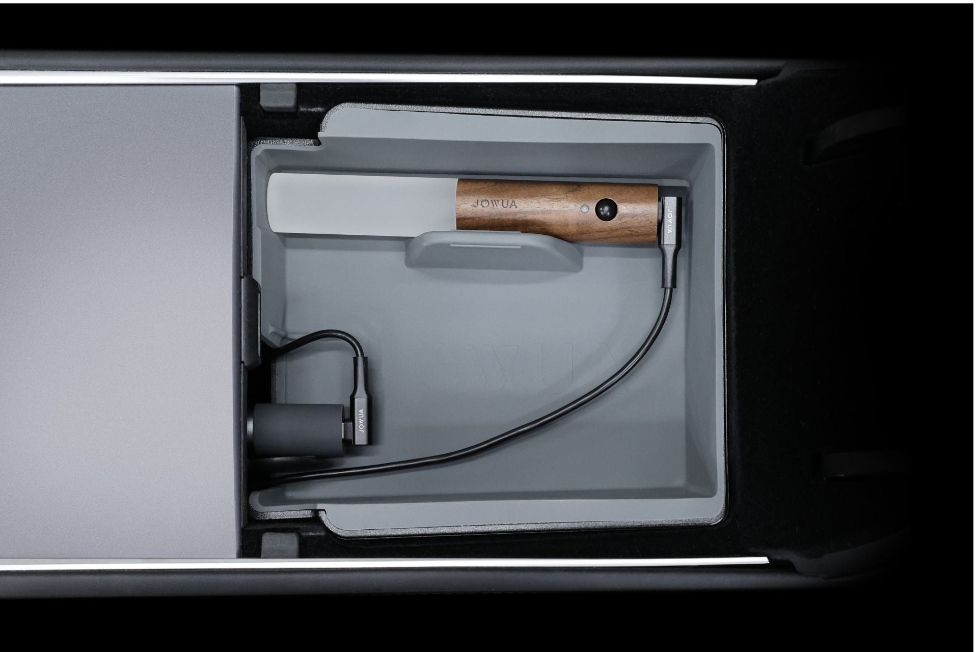 A well-organized car center console showcases a wooden-handled flashlight and charging cable, neatly stored within its compartments. The sleek, modern interior lighting of the JOWUA LED Light Bar for Tesla enhances the design, emphasizing functionality.