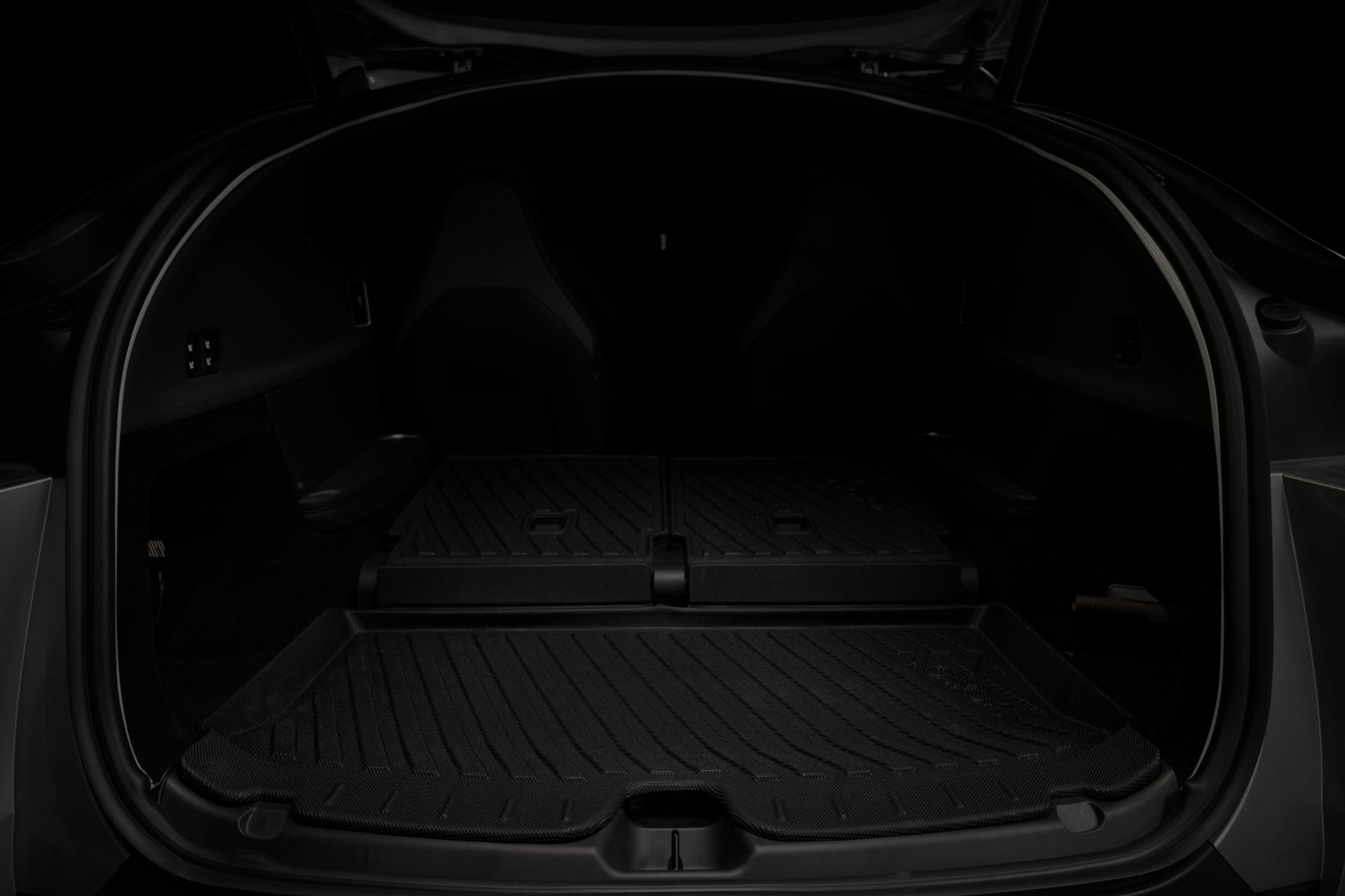 The image displays the trunk of a Tesla Model Y L with the rear seats folded down, revealing a flat, spacious cargo area lined with a protective mat in a dark interior. The empty trunk highlights ample room—ideal for adding the JOWUA Tesla Model Y L (2026+) Trunk Storage Bins + Ambient Light Bundle to keep your items neatly organized and enhance your vehicle’s practicality.