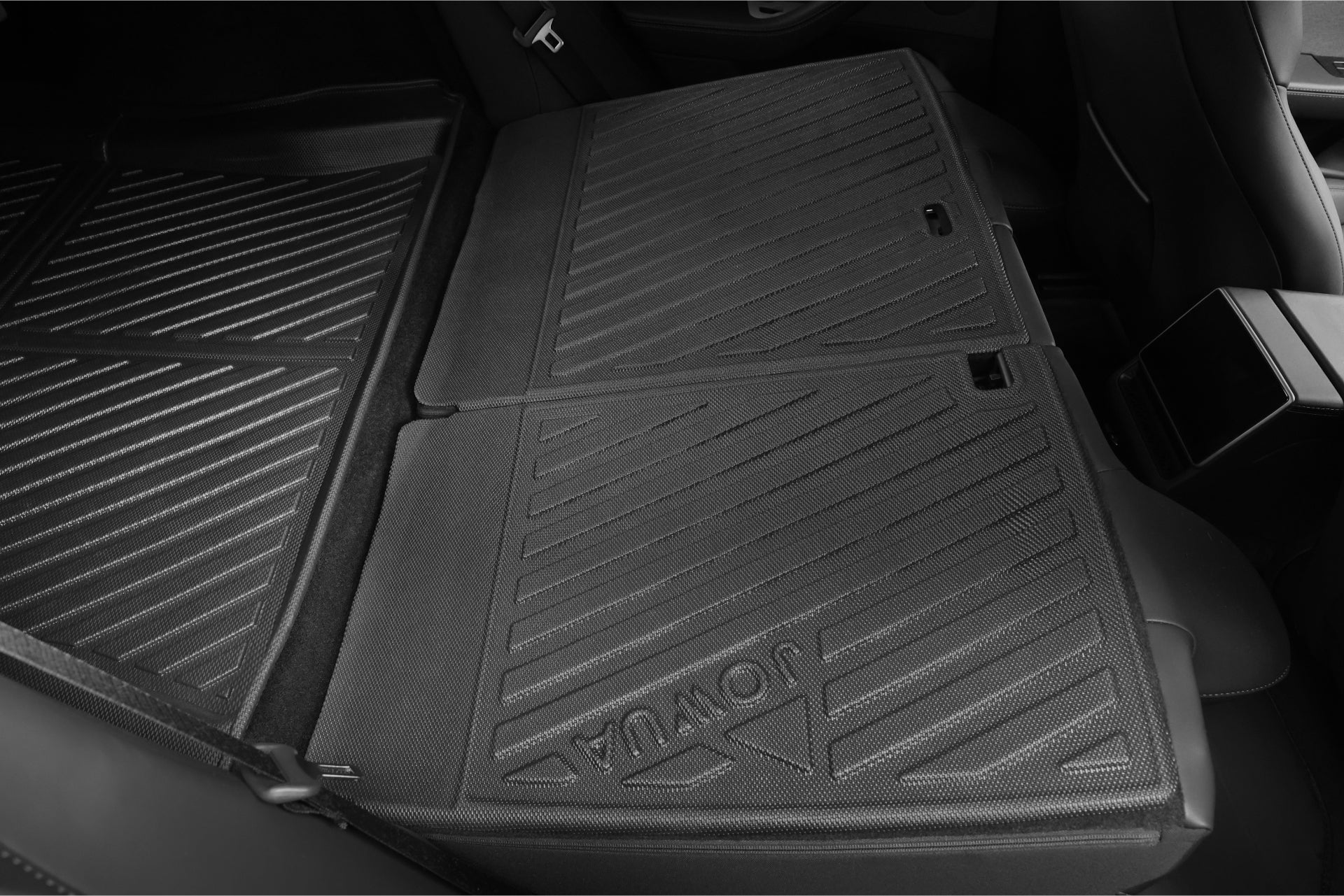 The interior view of this Tesla Model 3 highlights its rear seats folded flat, protected by the JOWUA Model 3 All Weather Trunk Combo designed for the Reengineered Model 3 Highland, 2024+. These waterproof TPE trunk liners feature grooved mats with a logo, offering a cohesive and easy-to-clean surface that combines style with functionality.
