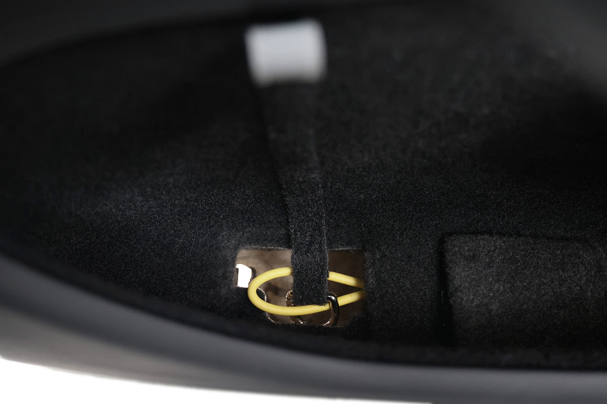 A close-up reveals a gold key ring on a fabric loop inside a black, felt-lined compartment—one of the refined touches featured in the JOWUA All-in-One Interior Upgrade Set for Model Y Standard (2026+).