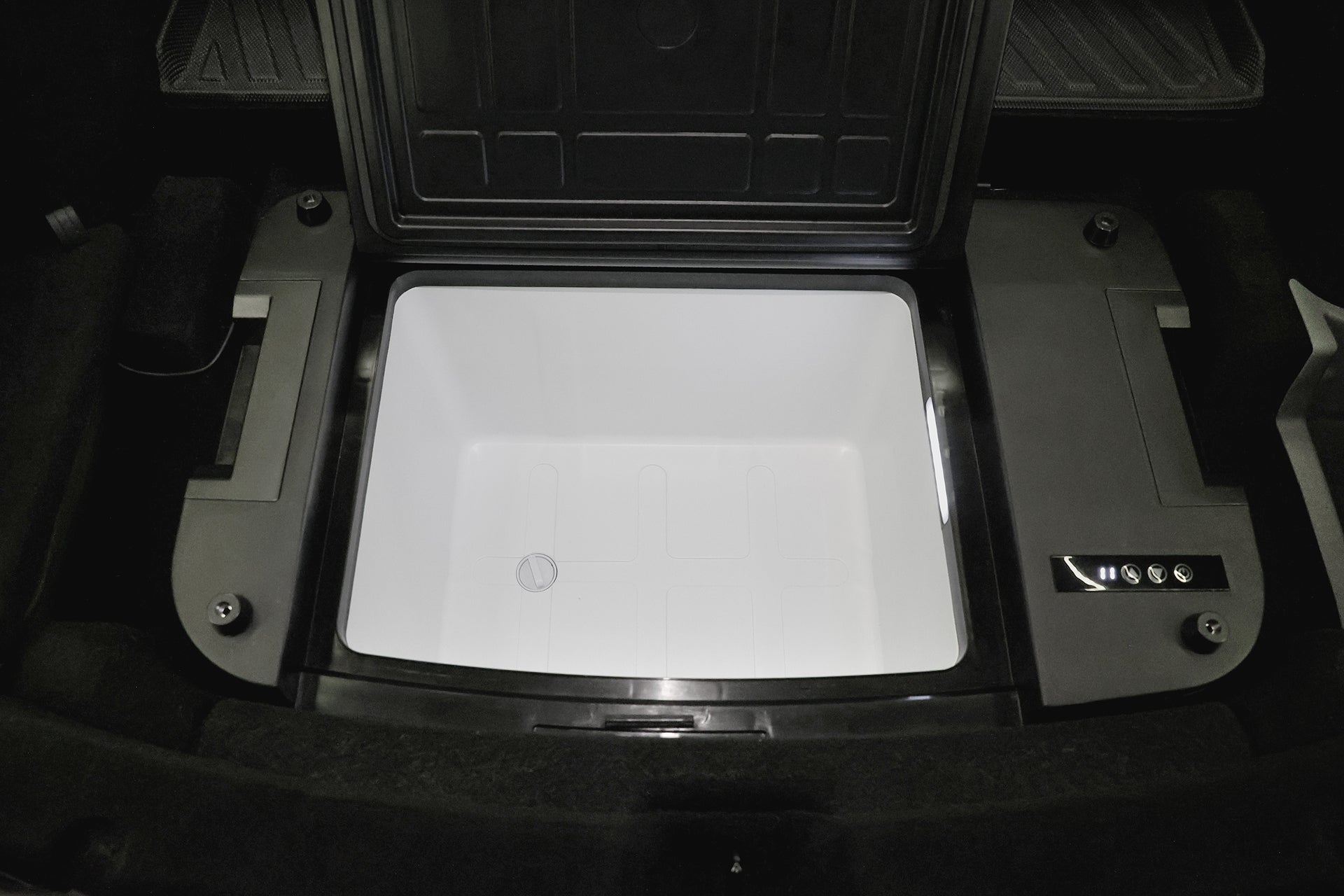 In the open trunk of a Tesla Model Y, a JOWUA Car Refrigerator with control buttons on the right and a black lid supports USB-C power mode for versatile charging.