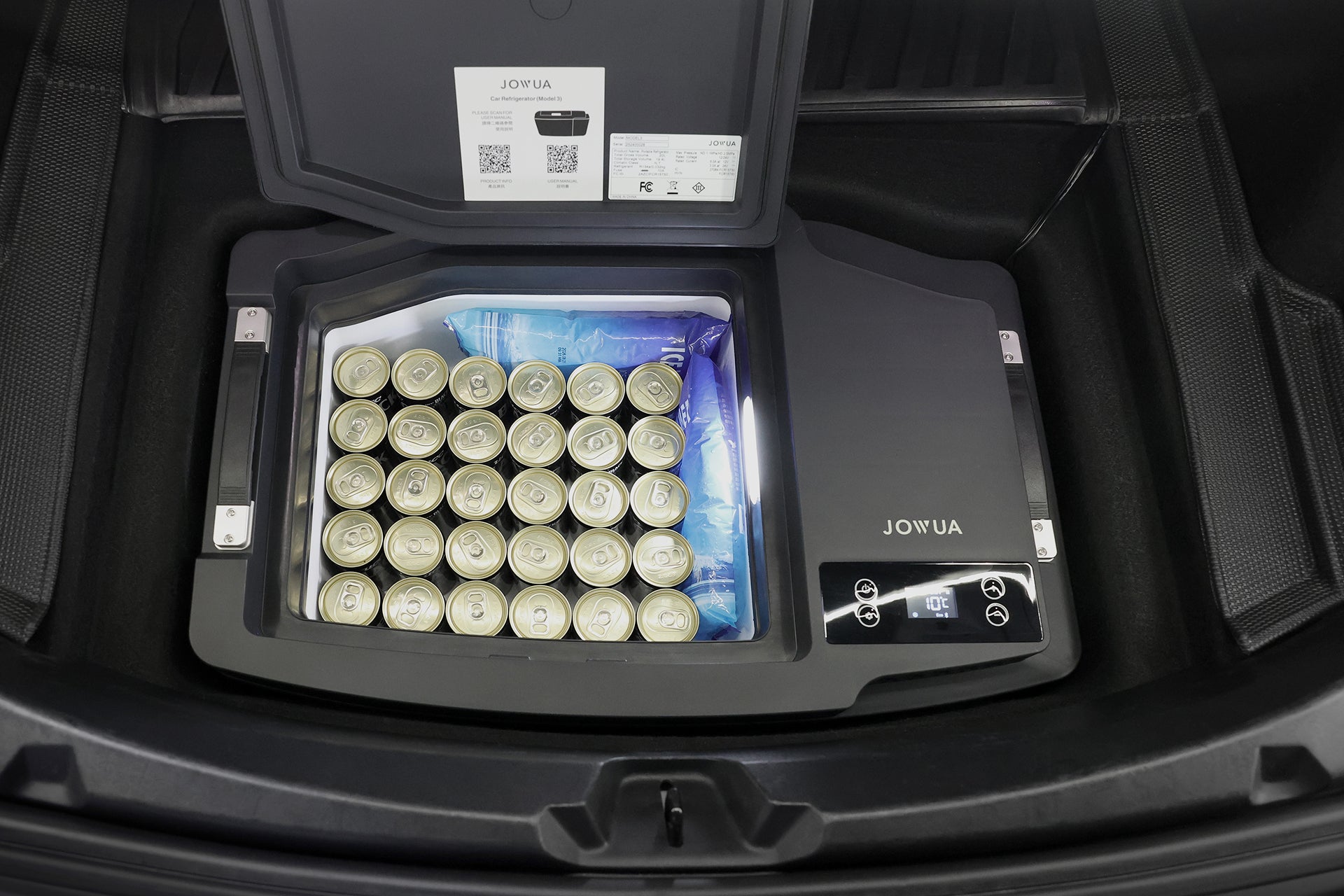 A JOWUA Car Refrigerator for Tesla Model 3 (Premium/Performance 2024-2026+) sits in an open trunk, filled with canned drinks and ice packs, featuring intelligent dual-mode cooling, a digital control panel, and an instruction sheet inside the lid.