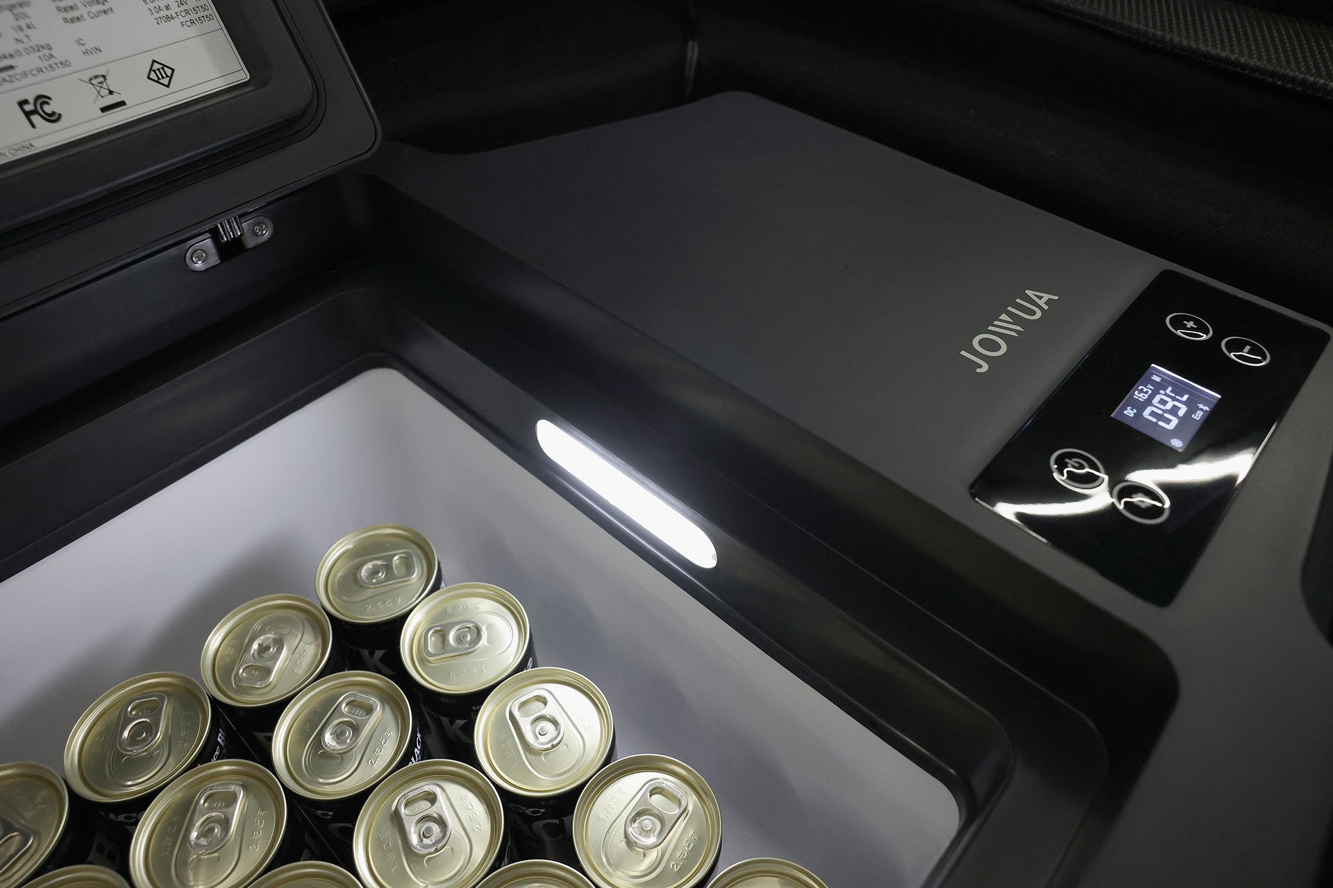 Close-up of the JOWUA Car Refrigerator for Tesla Model 3 (Premium/Performance 2024-2026+) with canned drinks inside, control panel set to -15°C for dual-mode cooling, and visible USB-C power system and branding.