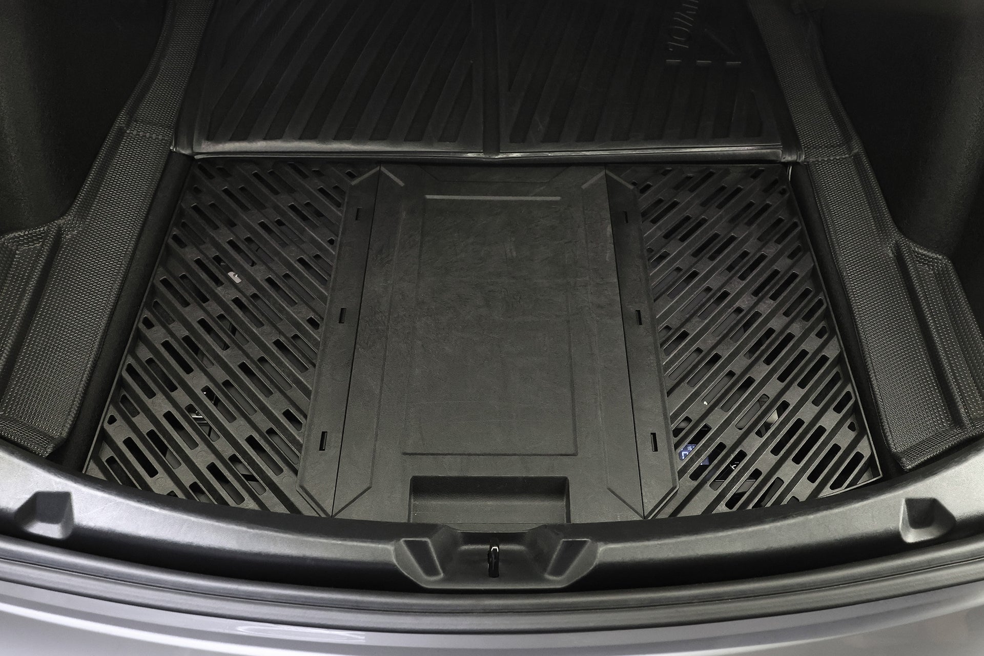 Close-up of a black cargo liner in a car trunk, designed to protect the floor—ideal for storing your JOWUA Car Refrigerator for Tesla Model 3 (Premium/Performance 2024-2026+) with its intelligent dual-mode cooling system.