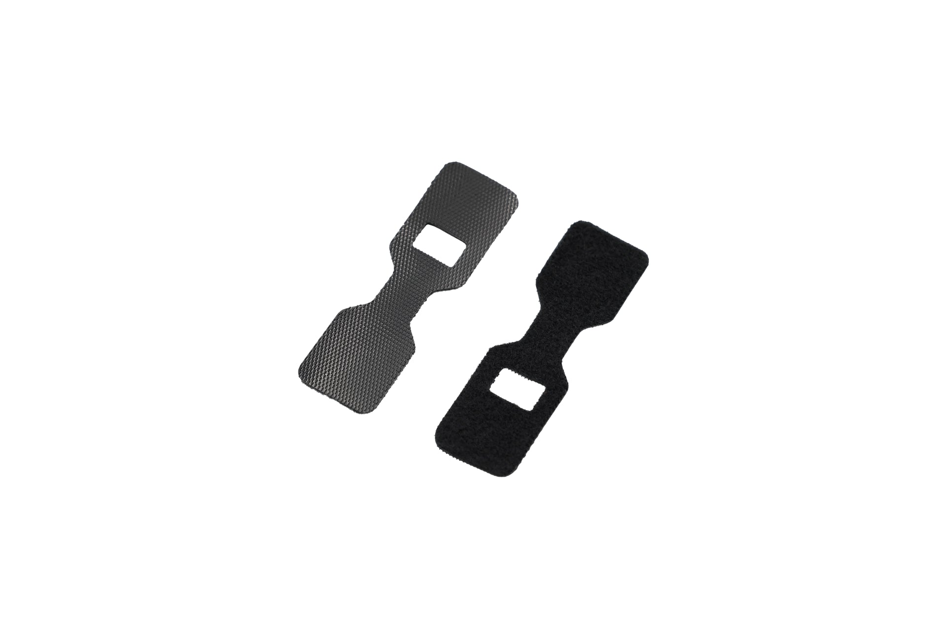 Two guitar strap locks in black, featuring squarish openings in the center and set against a white background, boast a textured appearance that mirrors the precision found in Tesla Model 3 accessories, dedicated to securely fastening guitar straps.