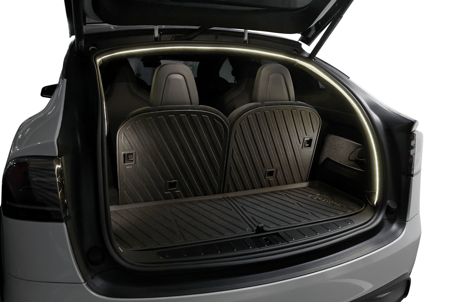 Open trunk of a white Tesla Model X with two upright rear seats and a black, grooved all-weather cargo mat; JOWUA Tesla Model X Trunk Ambient Light - USB-C LED Strip illuminates the trunk opening.