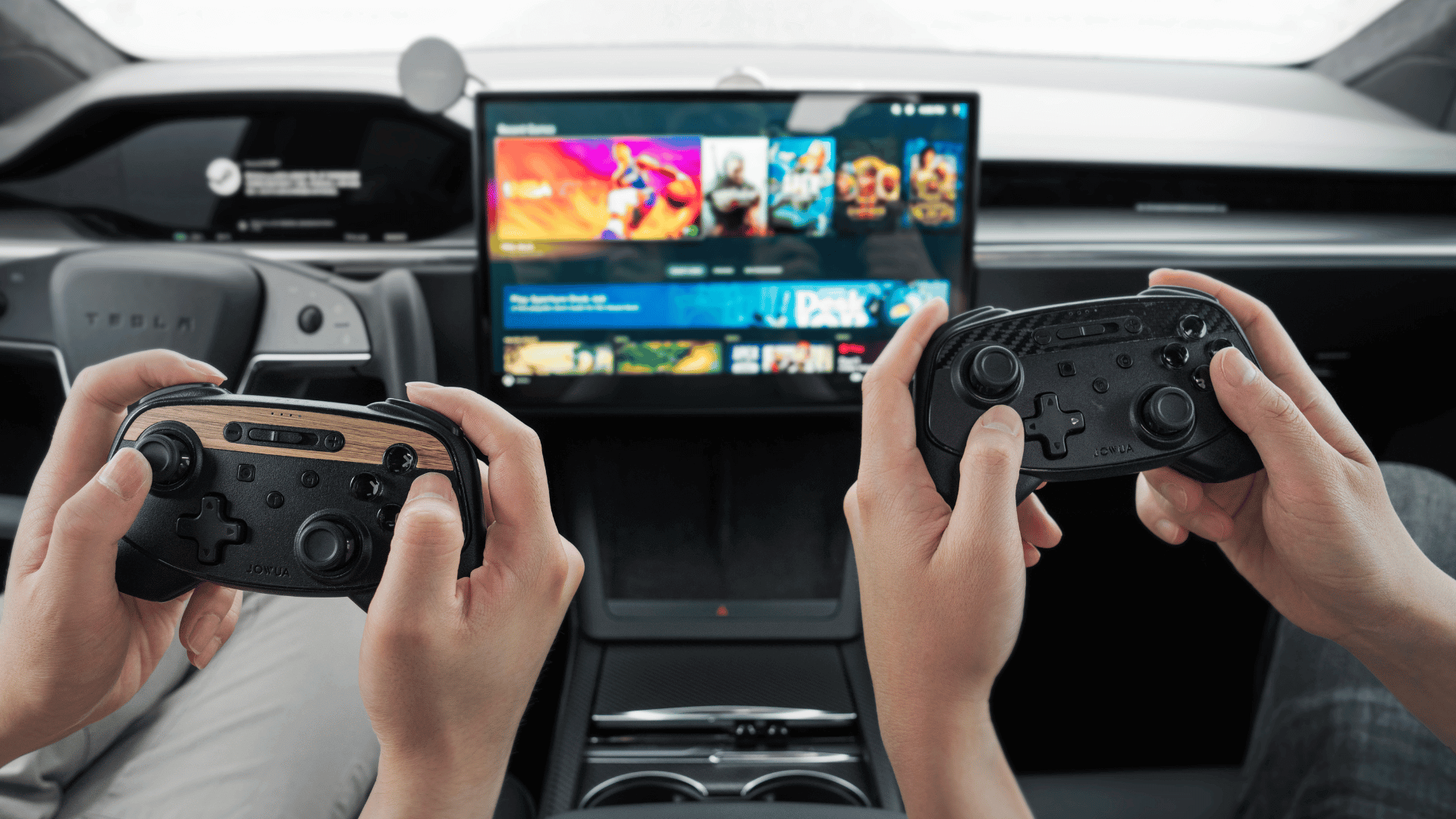Two people holding JOWUA's Wireless Tesla Game Controllers Combo in a car with a sleek and modern interior, while a screen displays various games in the background.