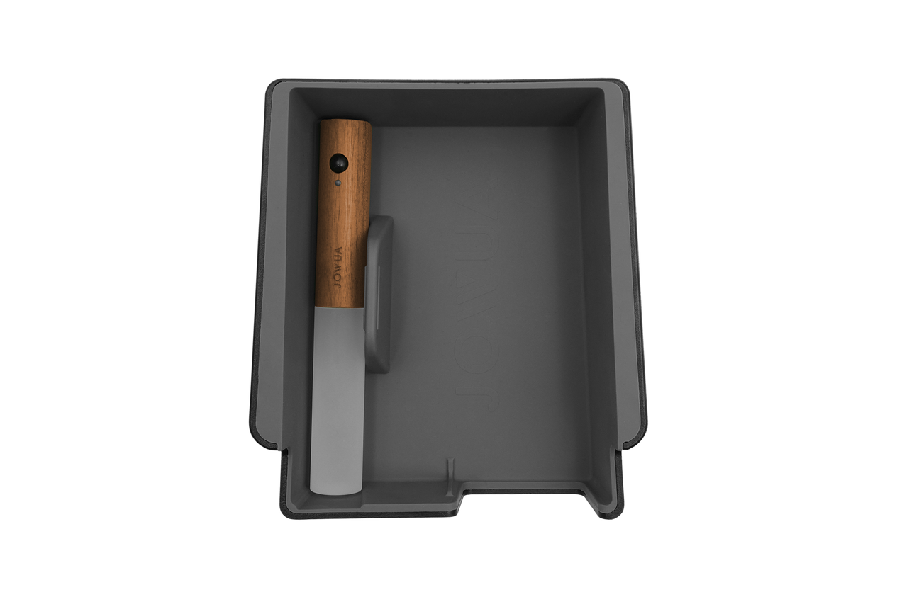 A premium Armrest Organizer for Tesla Model 3/Y by JOWUA, elegantly designed with a dark finish and crafted from high-quality hybrid materials, perfectly situated in a sleek black storage tray.