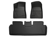 The image features three custom-fit, black rubber Model 3 All-Weather Floor Liners from JOWUA. These mats, specifically designed for Tesla Model 3 vehicles, have grooves and raised edges. The set includes two mats for the front seats and one for the rear.