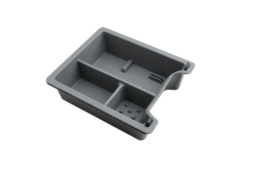 The JOWUA Center Console Tray Organizer for Tesla Model 3/Y is a gray plastic storage tray featuring multiple compartments and a textured base, designed to fit seamlessly into a larger box or drawer against a black background.