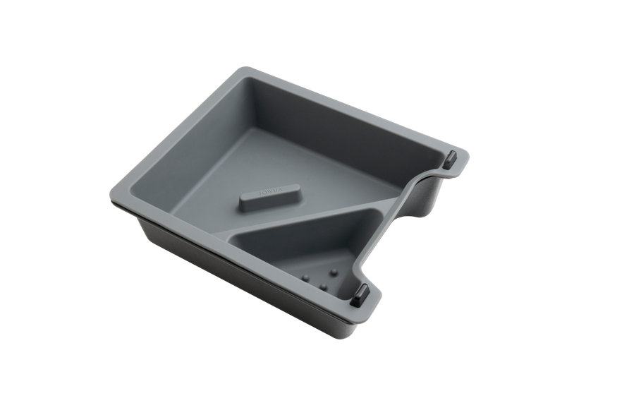 The JOWUA Center Console Tray Organizer for Tesla Model 3/Y is crafted from premium hybrid material and comes in gray. This rectangular plastic tray includes a slanted divider and a raised section at one end, making it ideal for organizing your center console. Part of the Tesla Model 3/Y accessories line, it boasts rounded edges and features an ergonomic handle on one side.