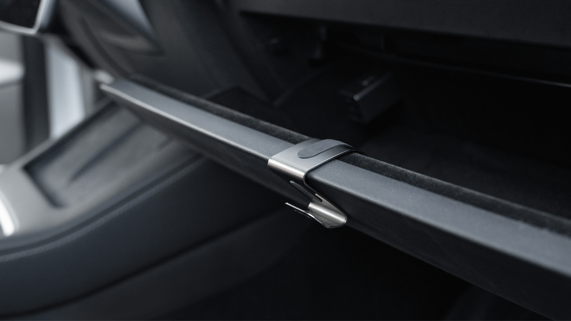 A close-up view of the interior in a JOWUA-enhanced Tesla Model 3 showcases a sleek, modern design with minimalist aesthetics and dark upholstery, highlighting part of the seat.