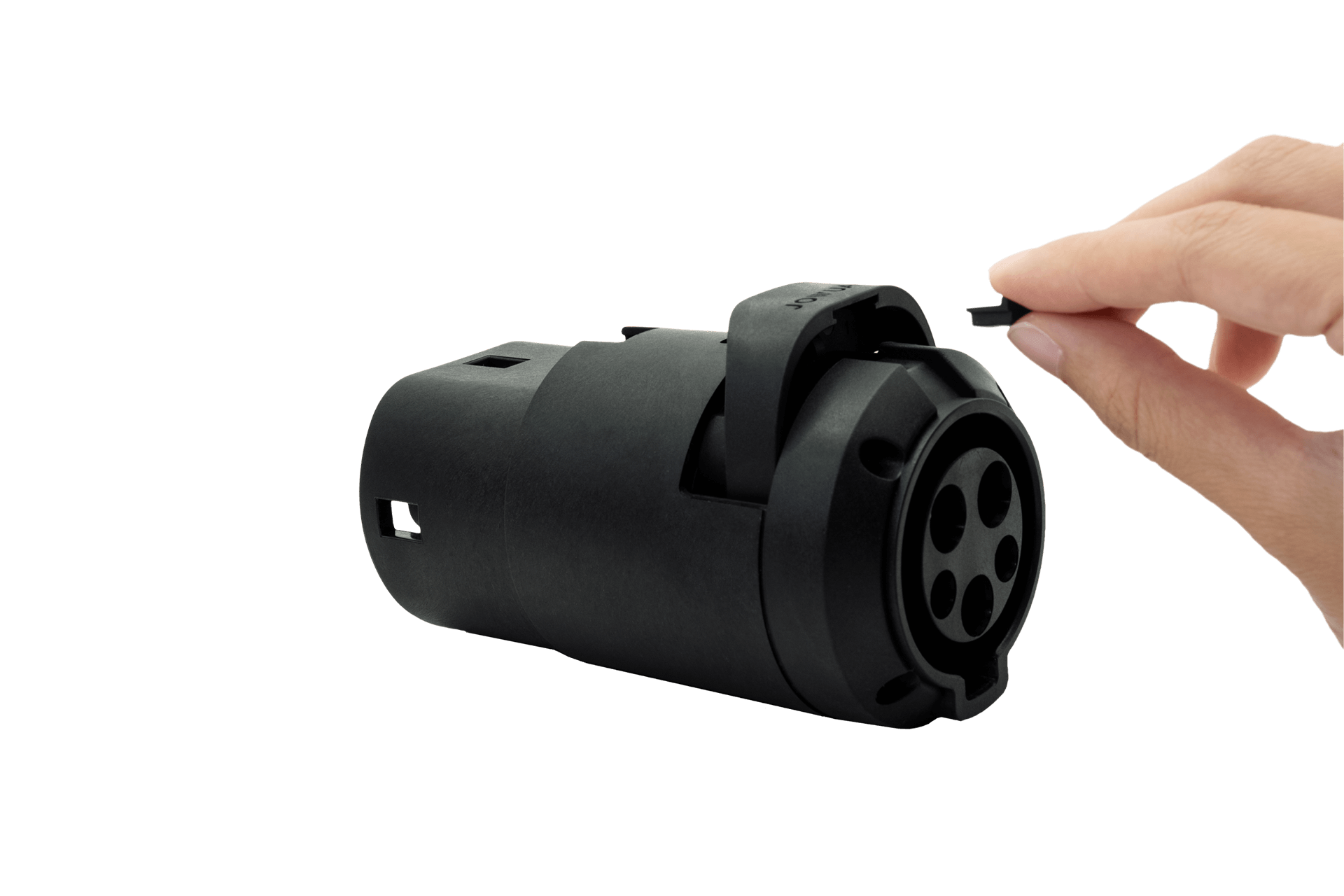 A hand is holding a black plastic cap next to a black cylindrical object featuring multiple circular ports, which appears to be the JOWUA J1772 to CCS2-AC (TYPE2) Adapter (Tesla Anti-pull), set against a plain background.