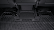 Close-up of a Model Y All-Weather Floor Liners Combo - Juniper Compatible (Right Hand Drive Version) by JOWUA under a rear seat, with a black "JOWUA" box centered between the seat rails—ideal for Tesla Model Y accessories.