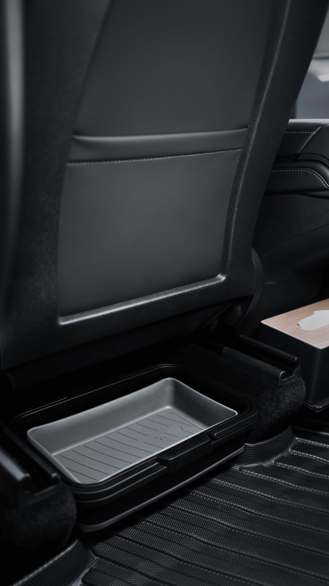 A close-up of a Tesla rear seat area shows JOWUA Under Seat Collapsible Organizers (Set of 2) for Model X/Y and rubber floor mats, with part of a tissue box visible on the right.