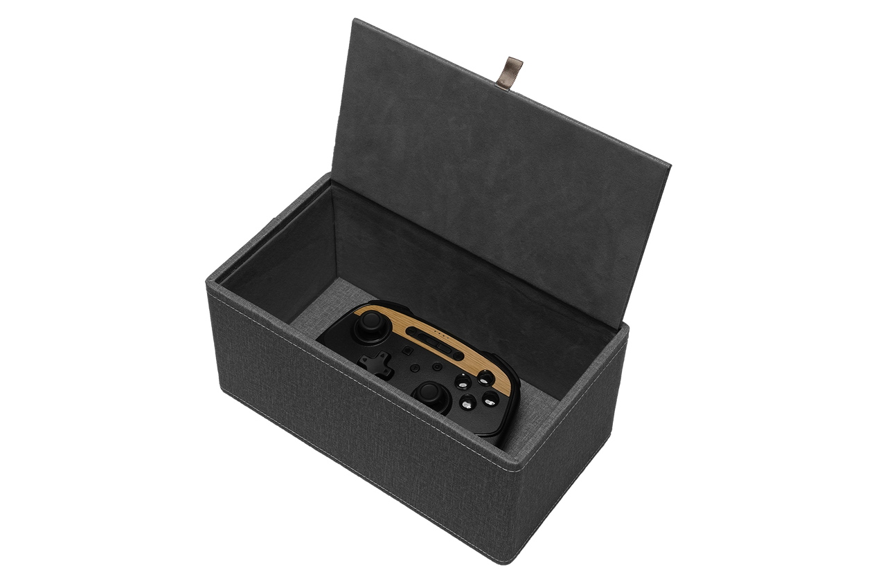 A JOWUA gaming controller in black and brown is nestled within the elegantly designed Tissue & Storage Box. Crafted with a premium fabric-like texture and featuring a small pull tab on the lid, this gray box offers versatile storage solutions for all your gaming needs.