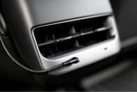 In a close-up view of the Tesla Model 3 interior, you can see an air vent with a sleek, modern design. A JOWUA Magnetic Charging Cable USB-C to USB-C (1M-1.8M), with its braided black design, is connected at the bottom right of the vent, ensuring quick and efficient power delivery for convenience on the go.